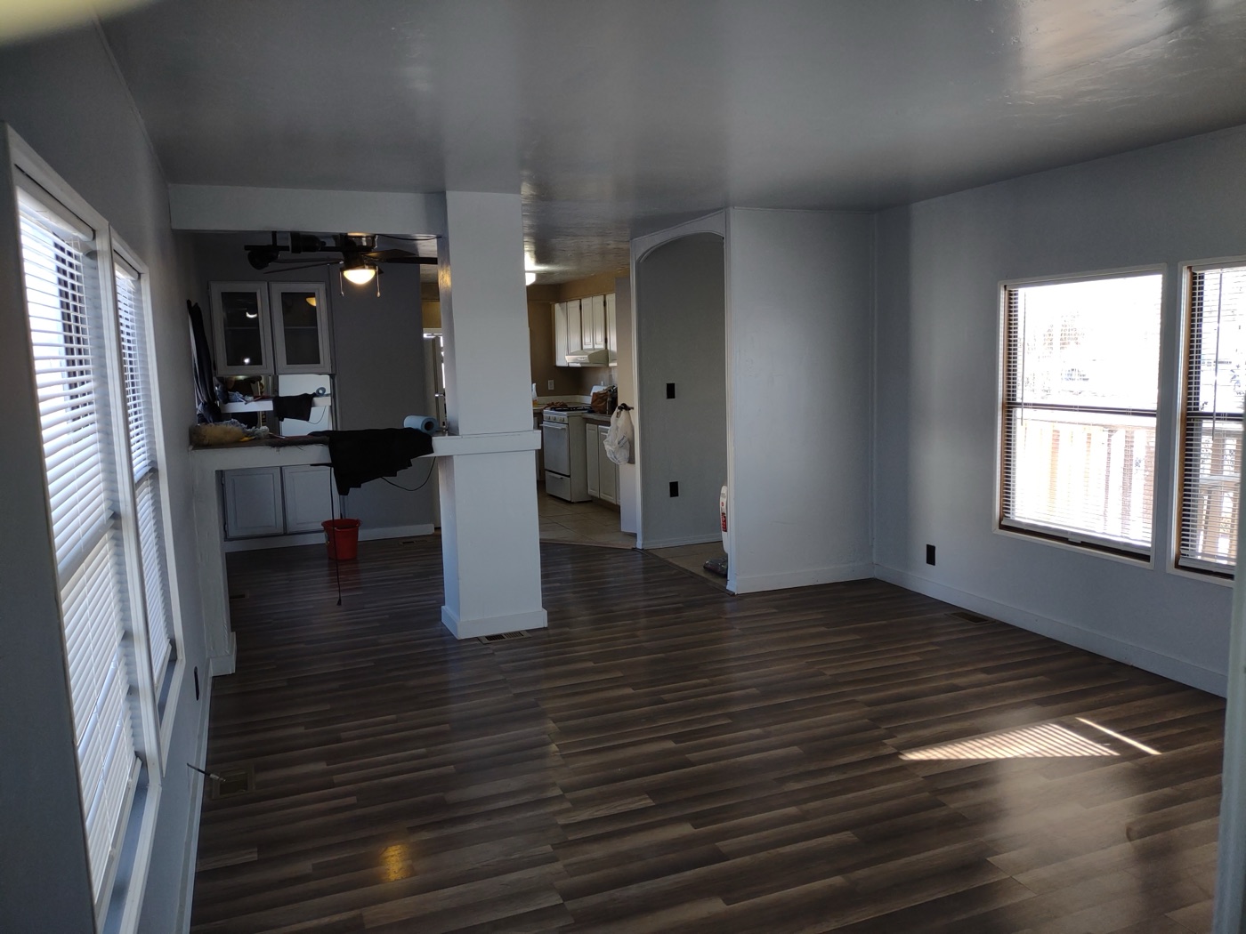 Open living and kitchen space finished by Honey Do List — fresh floors, clean walls, ready to live in